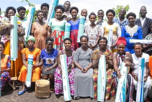 Participants holding rolled mats at a RISE activity