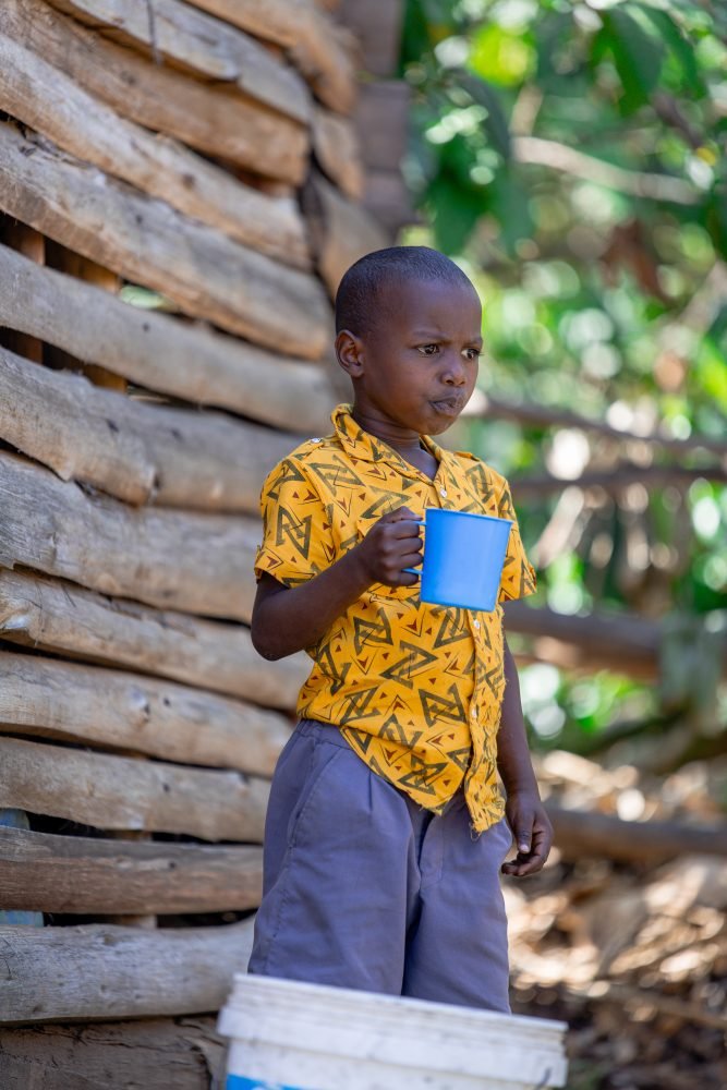 A pupil with his cup at school in Rukungiri