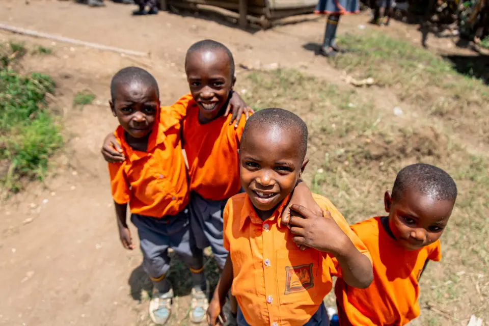 Four pupils smiling together at school