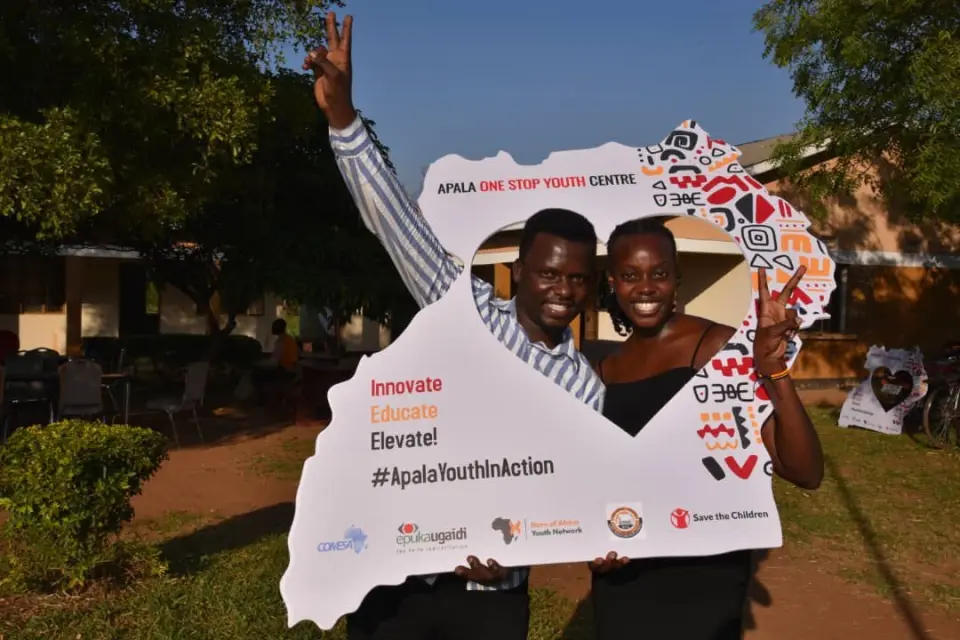Two young people smiling through an Apala One Stop Youth Centre photo frame