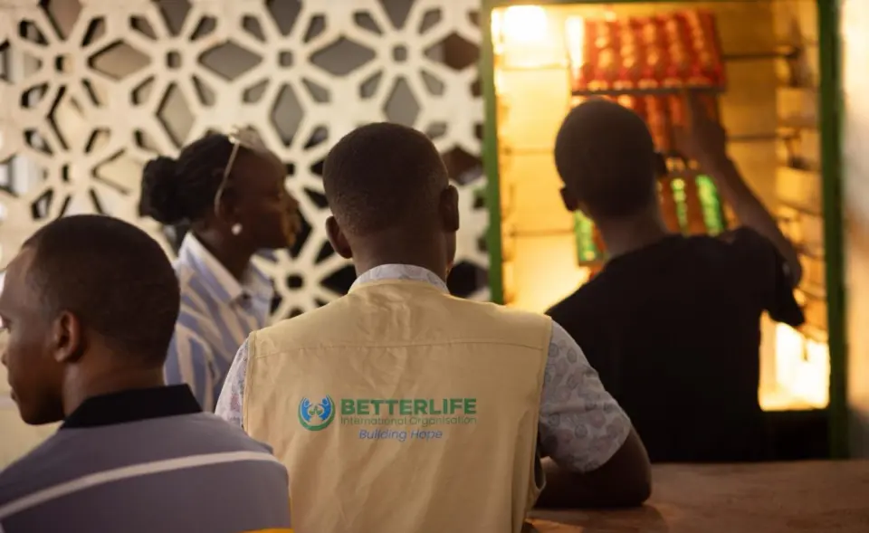 Trays of eggs in an incubator, with the BetterLife team looking on