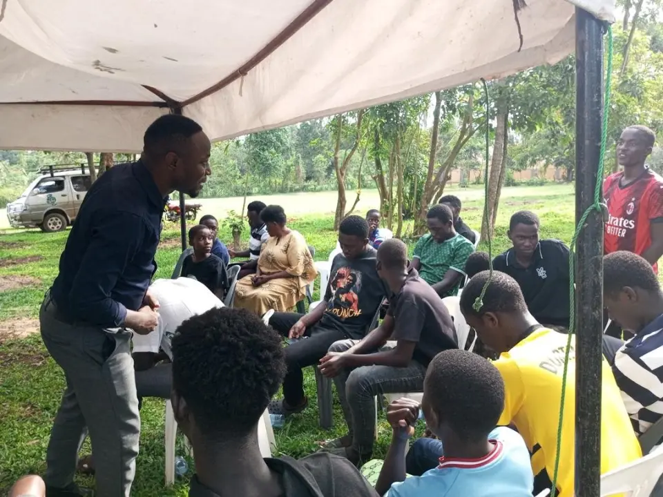 Young people at a training session under a tent in Karagwe