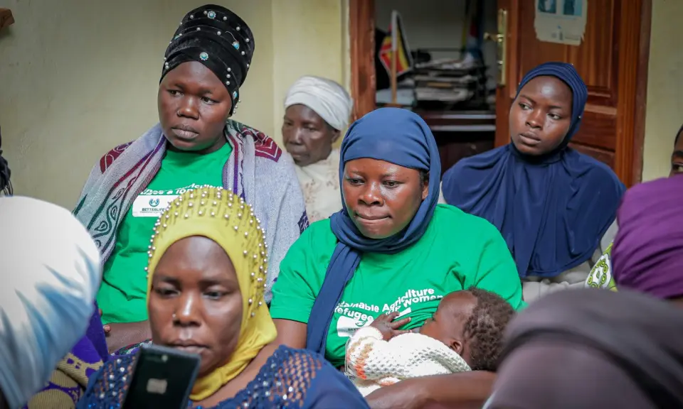 Women looking at a phone together during a session in Yumbe