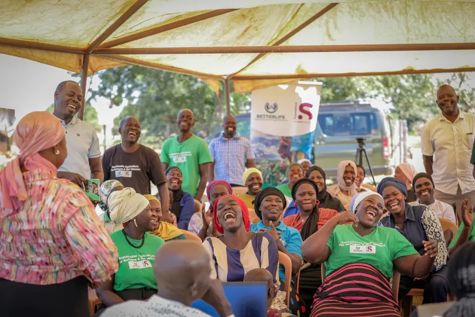 Women and the BetterLife team laughing together at a session in Yumbe