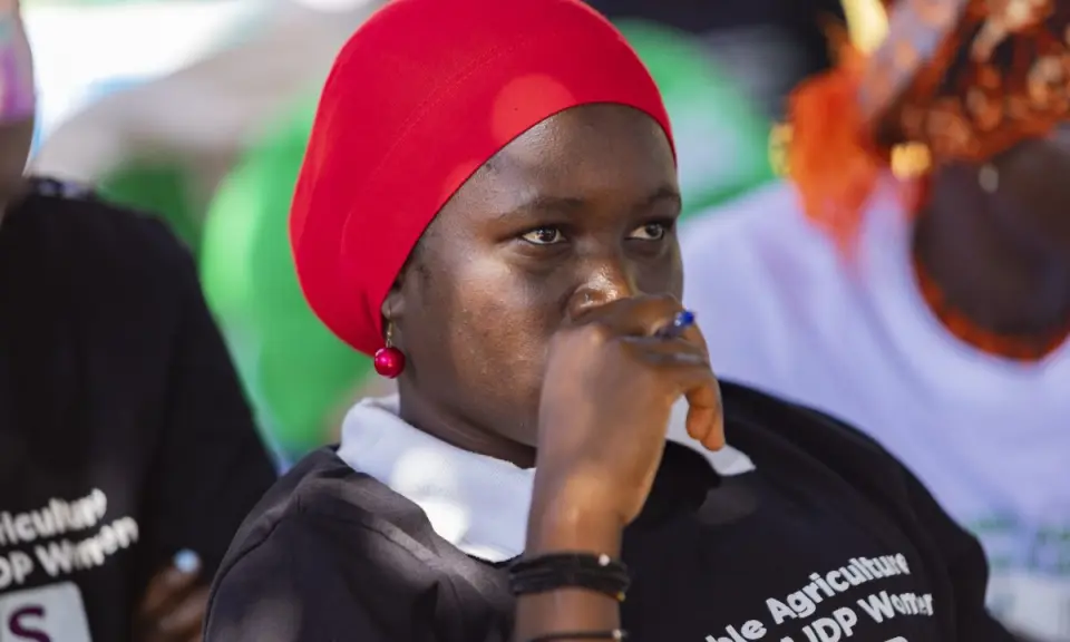 A participant listening during a training session in Yumbe